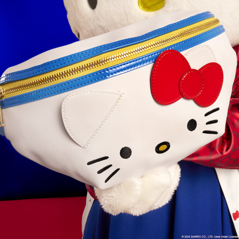 Hello Kitty holding the Loungefly Sanrio Hello Kitty 50th Anniversary Cosplay Convertible Belt Bag up to camera 